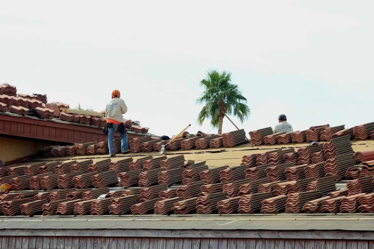 Roofing crew at work on a tile roof